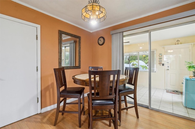 dining room featuring crown molding and wood-type flooring