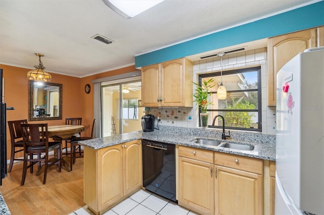 kitchen featuring sink, light tile patterned floors, light stone counters, black dishwasher, and white fridge