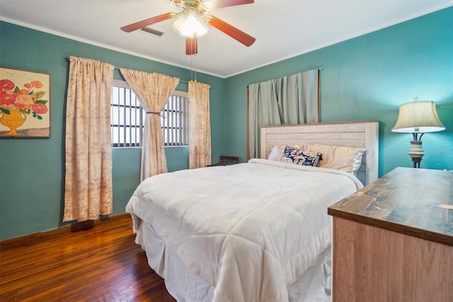 bedroom featuring ceiling fan, crown molding, and dark hardwood / wood-style floors