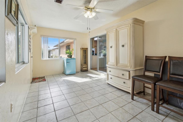 sitting room featuring light tile patterned floors and ceiling fan