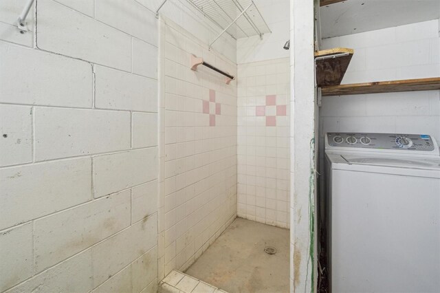 bathroom with a shower and washer / clothes dryer