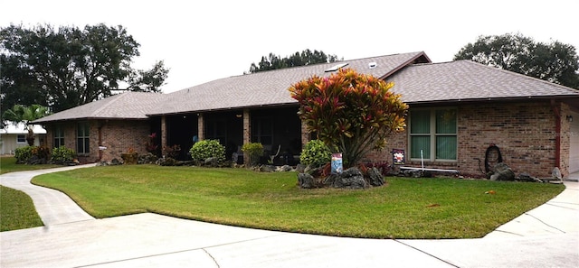 ranch-style house featuring a front lawn and a garage