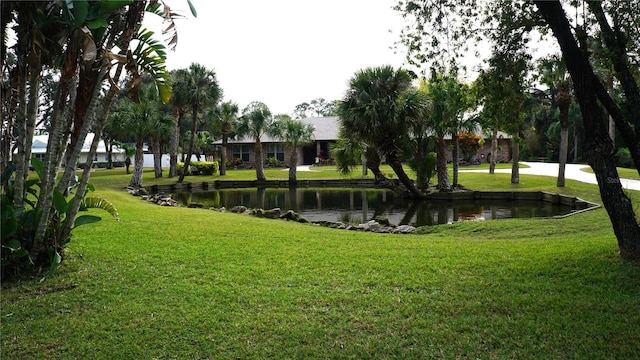 view of home's community featuring a yard and a water view