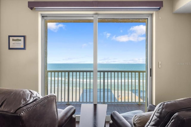 living room with a water view and a beach view