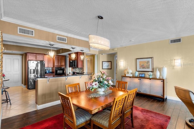 dining space featuring crown molding and a textured ceiling