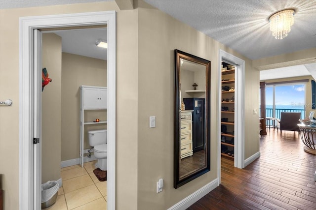 hallway with wood-type flooring and a textured ceiling