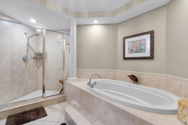 bathroom with tile patterned floors, separate shower and tub, and decorative columns