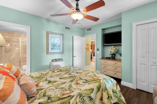 bedroom featuring dark hardwood / wood-style floors, ensuite bath, ceiling fan, a textured ceiling, and a closet