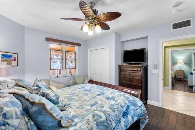 bedroom featuring ceiling fan, hardwood / wood-style floors, and a closet