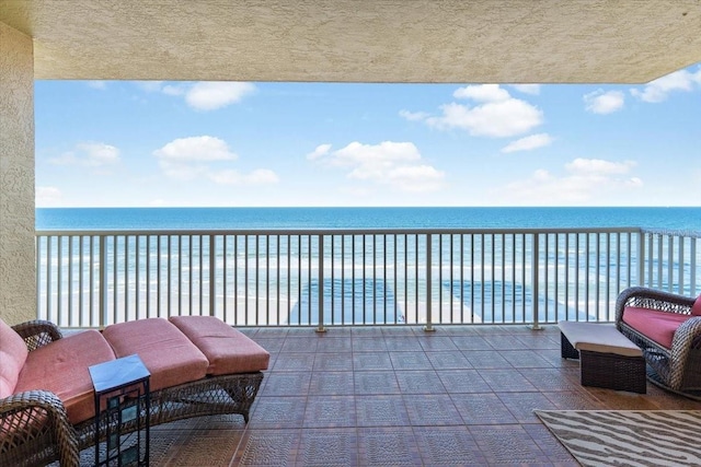 balcony with a beach view and a water view