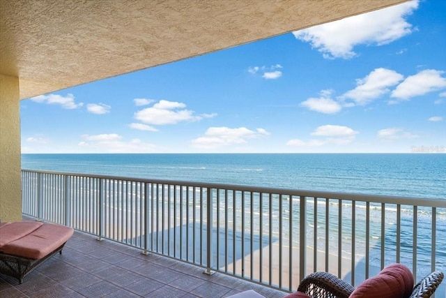 balcony with a view of the beach and a water view