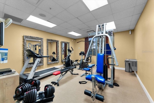 exercise room with a paneled ceiling