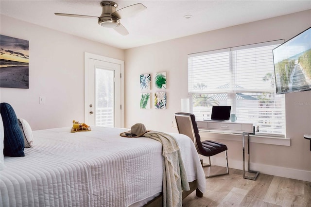 bedroom featuring ceiling fan, multiple windows, and light hardwood / wood-style flooring