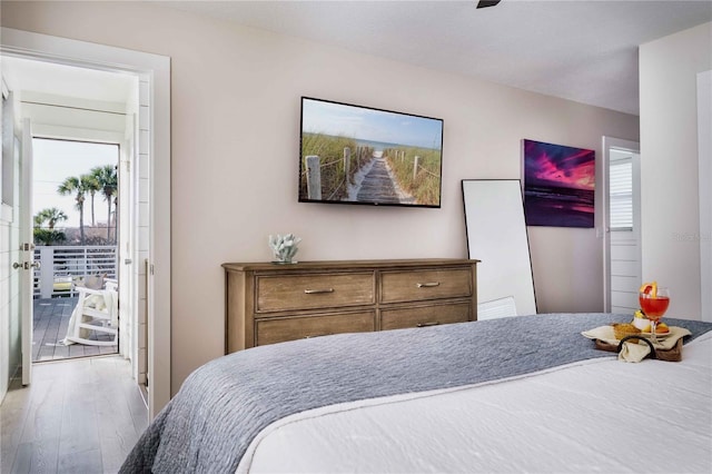 bedroom with hardwood / wood-style floors and multiple windows