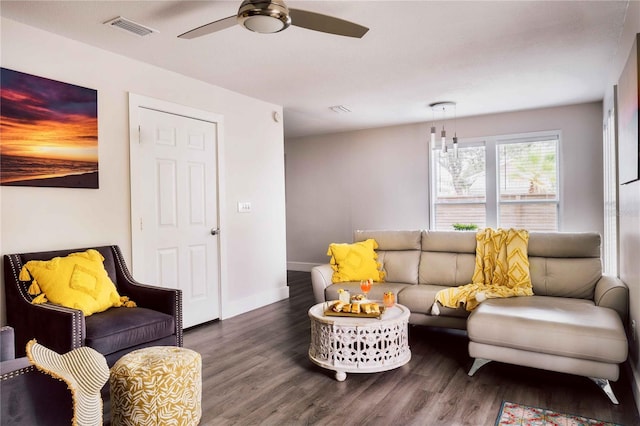 living room with ceiling fan and dark hardwood / wood-style flooring