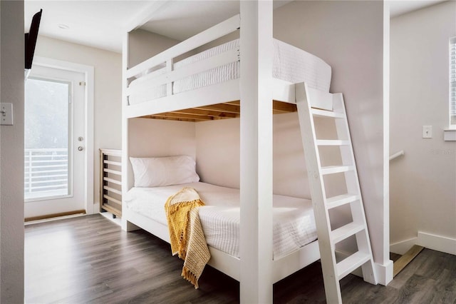 bedroom with dark wood-type flooring and multiple closets