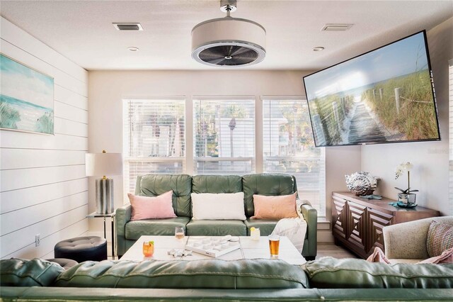 living room with wooden walls and wood-type flooring