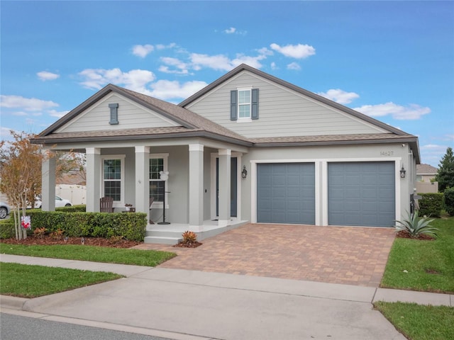 view of front of house featuring a garage and covered porch