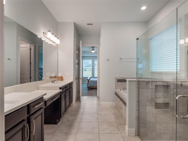 bathroom featuring vanity, ceiling fan, plus walk in shower, and tile patterned flooring