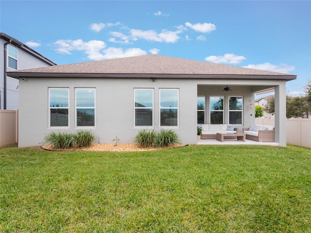 rear view of property with ceiling fan, outdoor lounge area, and a yard