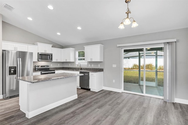 kitchen featuring a center island, pendant lighting, sink, white cabinetry, and stainless steel appliances