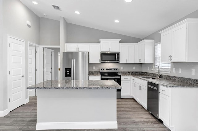 kitchen featuring sink, white cabinets, appliances with stainless steel finishes, and a kitchen island