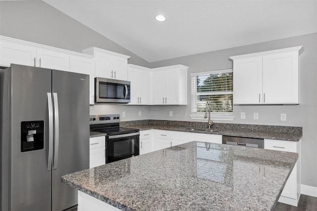 kitchen featuring white cabinetry, sink, stainless steel appliances, and a center island