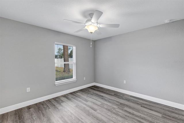 empty room featuring ceiling fan and hardwood / wood-style floors