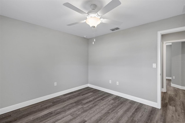 spare room with ceiling fan and dark hardwood / wood-style flooring