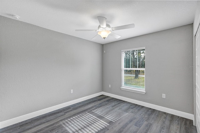 unfurnished room featuring ceiling fan and dark hardwood / wood-style floors