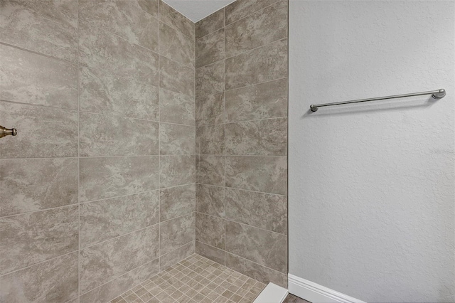 bathroom with tiled shower