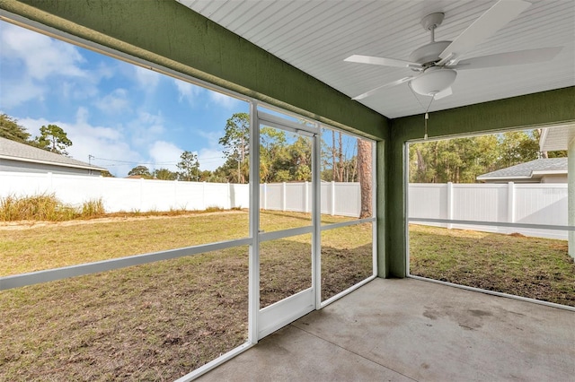 unfurnished sunroom featuring ceiling fan and plenty of natural light