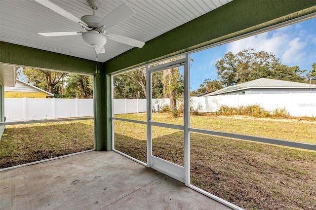 unfurnished sunroom featuring ceiling fan