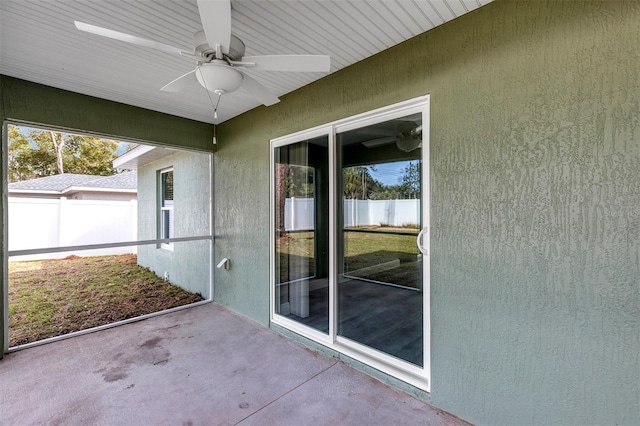 unfurnished sunroom featuring ceiling fan