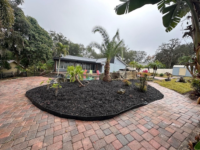 view of patio / terrace featuring a sunroom