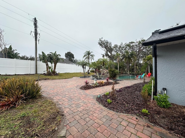 view of yard with a fenced in pool and a patio