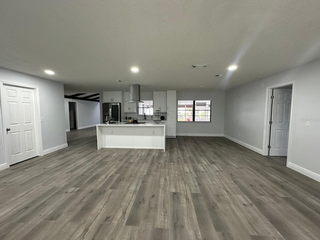 unfurnished living room with dark wood-type flooring