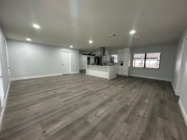 unfurnished living room with dark hardwood / wood-style floors