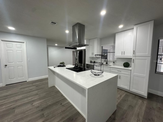 kitchen featuring island exhaust hood, white cabinetry, dark hardwood / wood-style flooring, and black electric cooktop