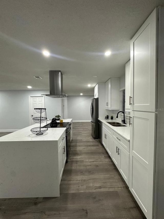 kitchen featuring appliances with stainless steel finishes, white cabinetry, dark hardwood / wood-style flooring, sink, and island range hood