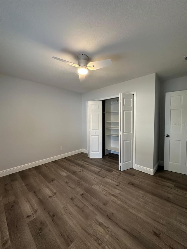 unfurnished bedroom with ceiling fan, a closet, and dark hardwood / wood-style flooring