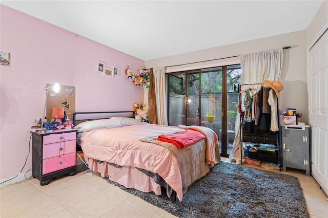 bedroom with light tile patterned flooring and access to exterior