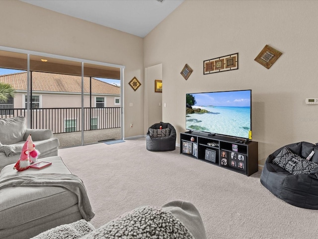 carpeted living room with vaulted ceiling