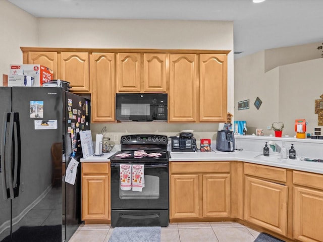 kitchen with light tile patterned flooring, sink, and black appliances