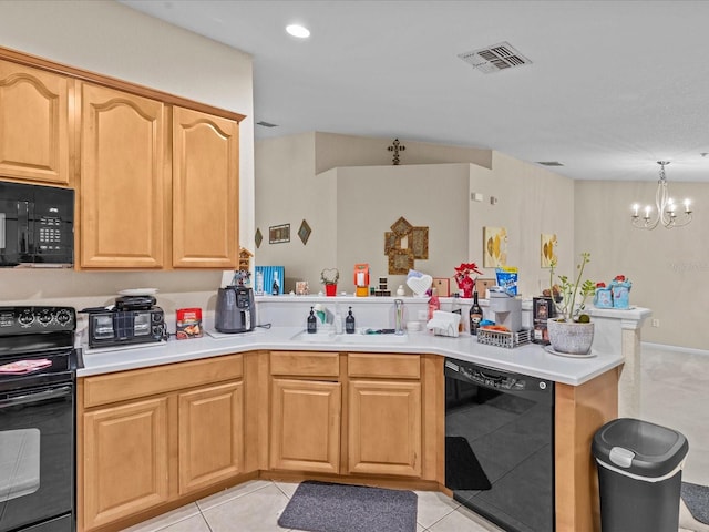 kitchen featuring decorative light fixtures, black appliances, sink, light tile patterned floors, and kitchen peninsula