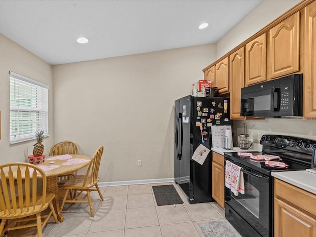 kitchen with light tile patterned floors and black appliances