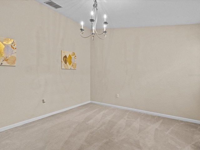 unfurnished room with light carpet and a notable chandelier