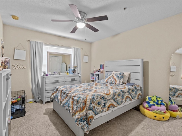 carpeted bedroom with a textured ceiling and ceiling fan