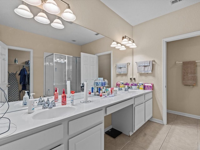 bathroom featuring a chandelier, vanity, an enclosed shower, and tile patterned flooring