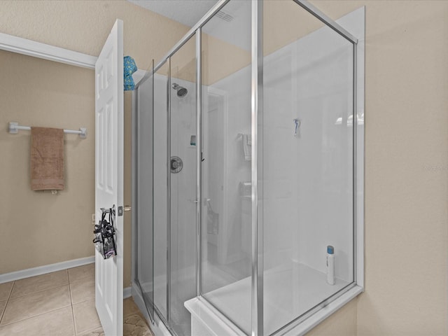 bathroom featuring walk in shower and tile patterned flooring